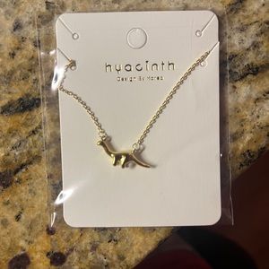 Gold plated dinosaur necklace.